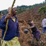 People trek through the rubble of a massive landslide in the Bulambuli district of Eastern Uganda.