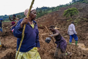 People trek through the rubble of a massive landslide in the Bulambuli district of Eastern Uganda.