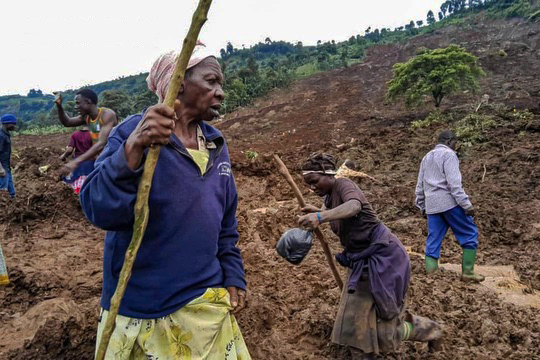 People trek through the rubble of a massive landslide in the Bulambuli district of Eastern Uganda.